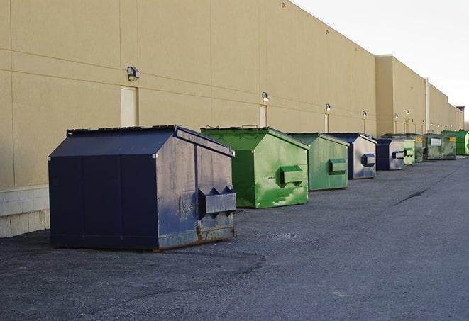 a construction worker disposing of debris into a dumpster in Oaktown